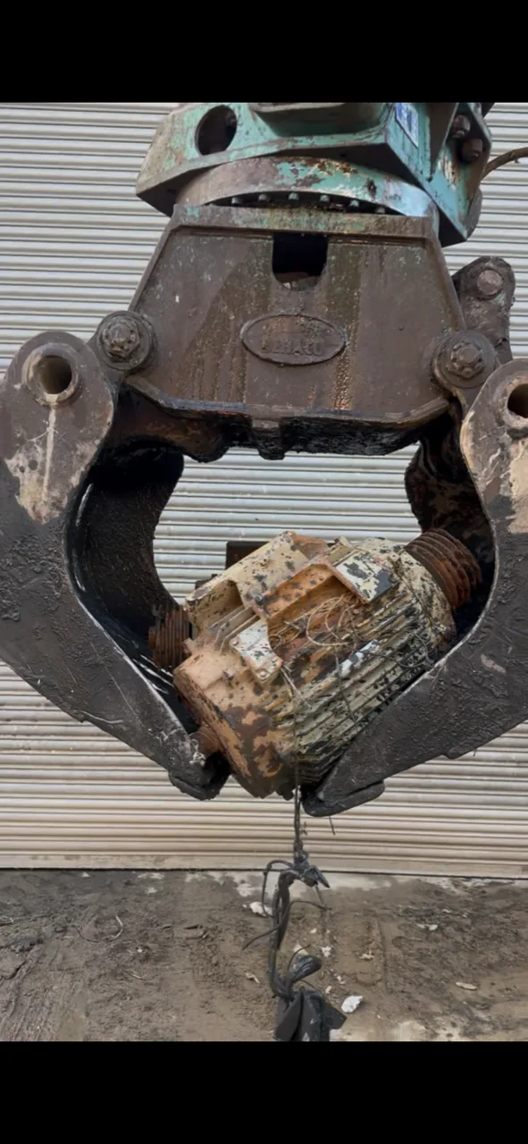 Electric motor held by Liebherr grab